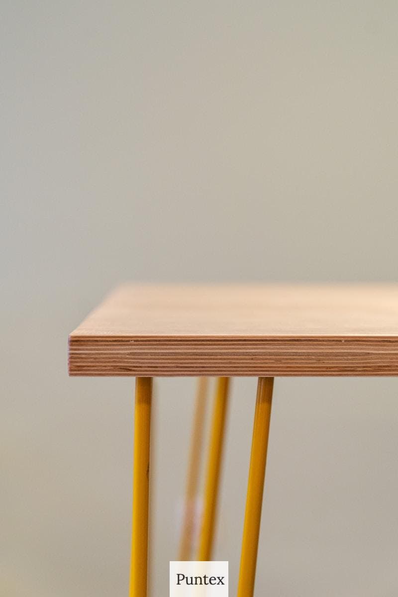 brown wooden table with yellow steel frame