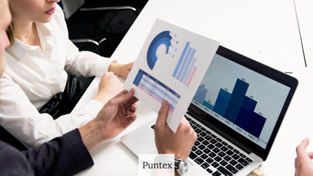 Business professionals discussing data charts and graphs in a modern office setting.